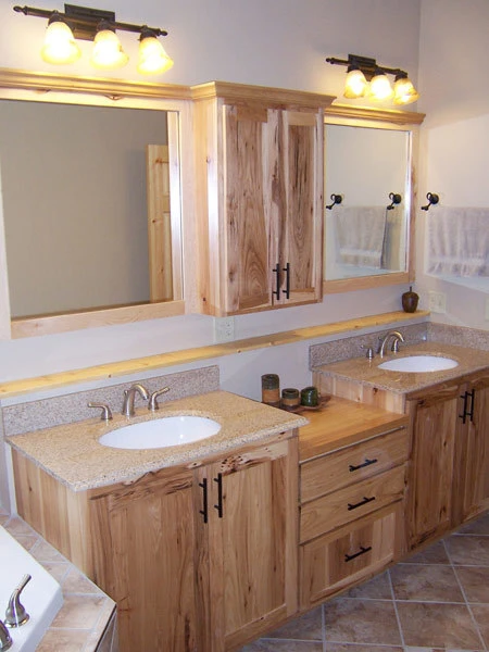 Finished bathroom with a custom hickory double vanity and granite tops, built by Powerbuilt Construction