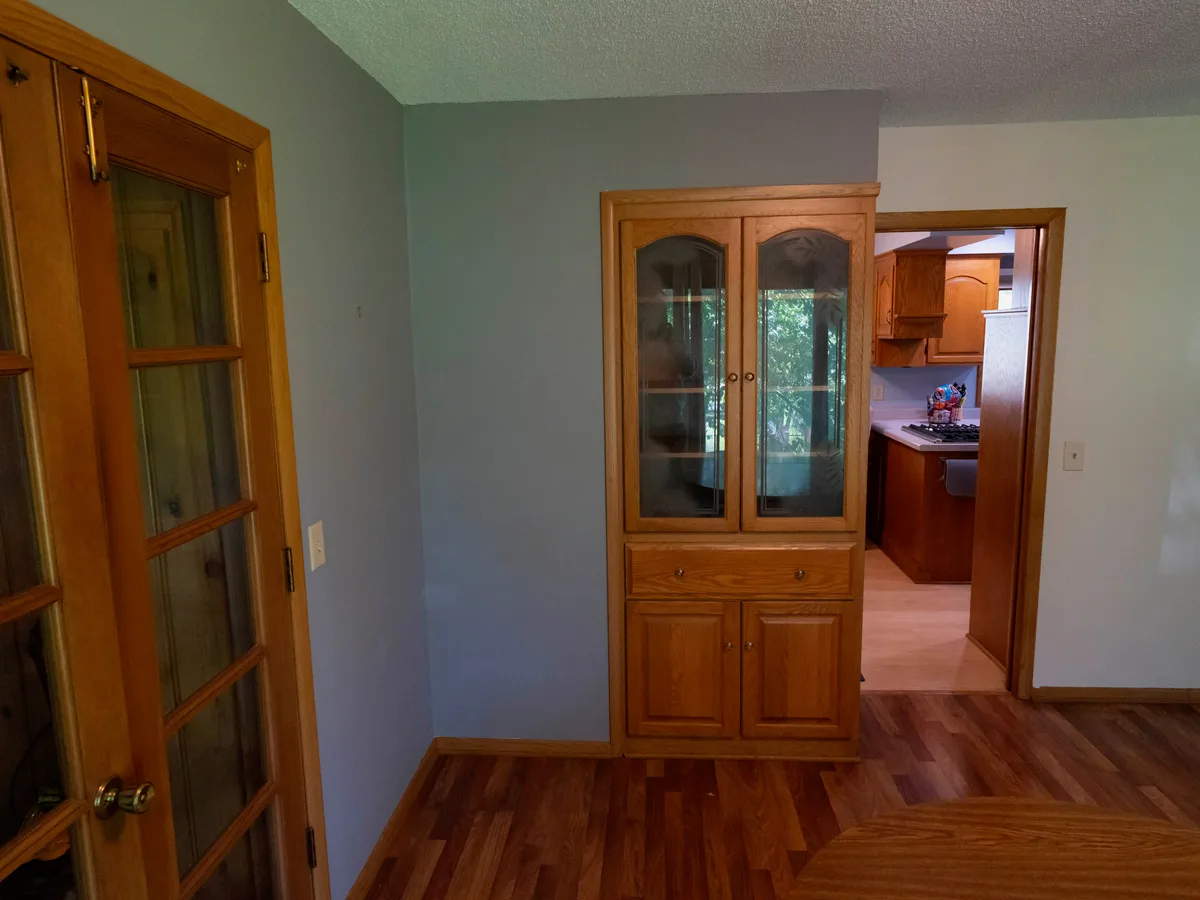 Dated oak kitchen and built-in hutch before Powerbuilt Construction remodeled it