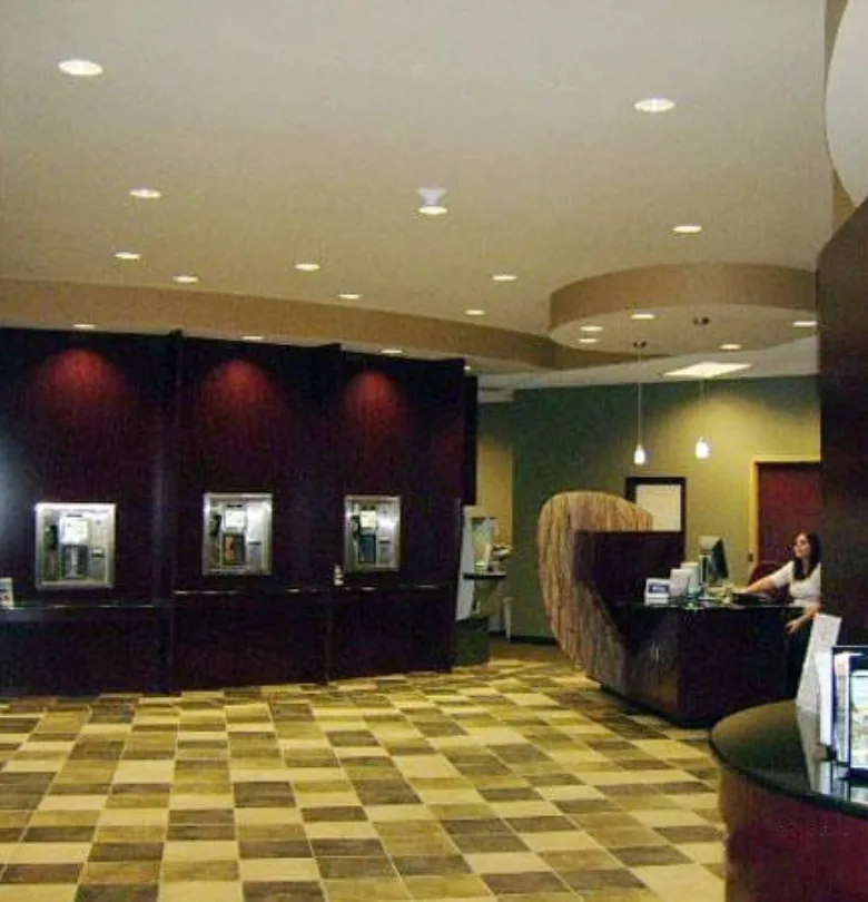 Finished bank interior with teller stations and a curved reception desk in Superior, Wisconsin, built by Powerbuilt Construction