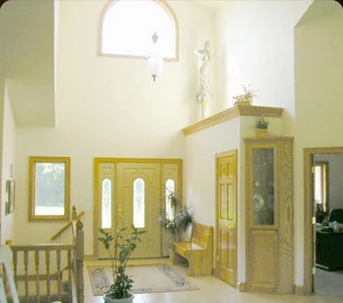 Two-story entry and staircase inside a finished custom home, built by Powerbuilt Construction