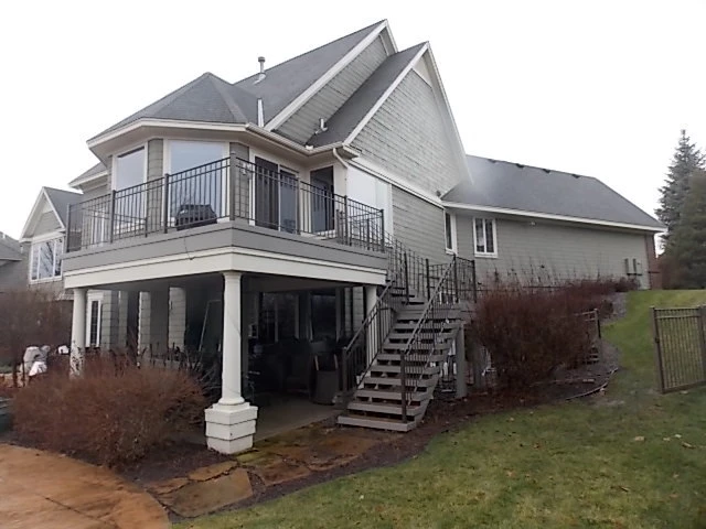 Elevated walkout deck over a covered patio on a North Metro home, built by Powerbuilt Construction